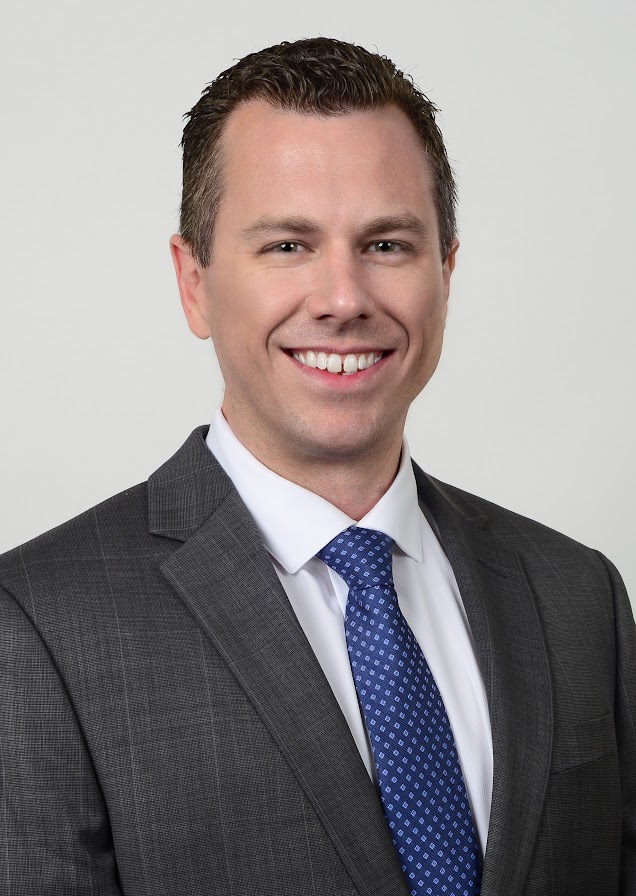 Professional Corporate Headshot Of A Male Executive In A Gray Suit With Blue Tie, Photographed By Goodluckstef Productions
