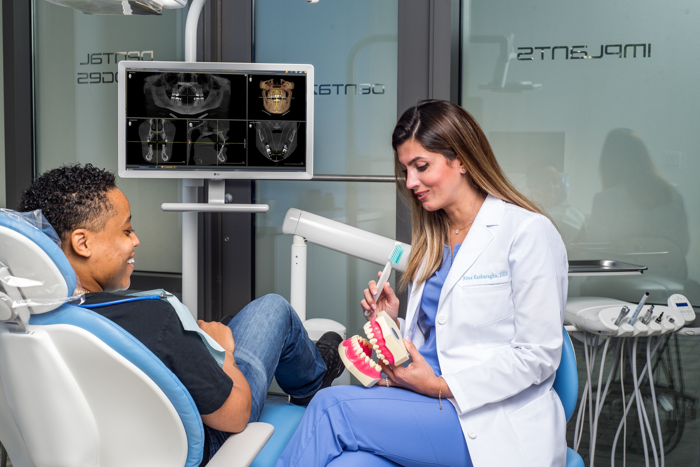 Dentist Consulting With Patient In Modern Dental Office - Goodluckstef Productions